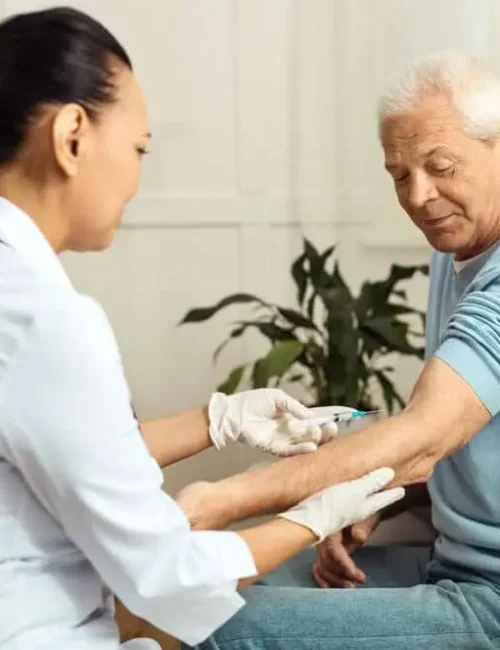 Nurse_giving_a_resident_medication_through_an_injection_d973e19f62